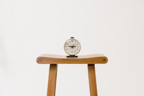 Clock on wooden stool